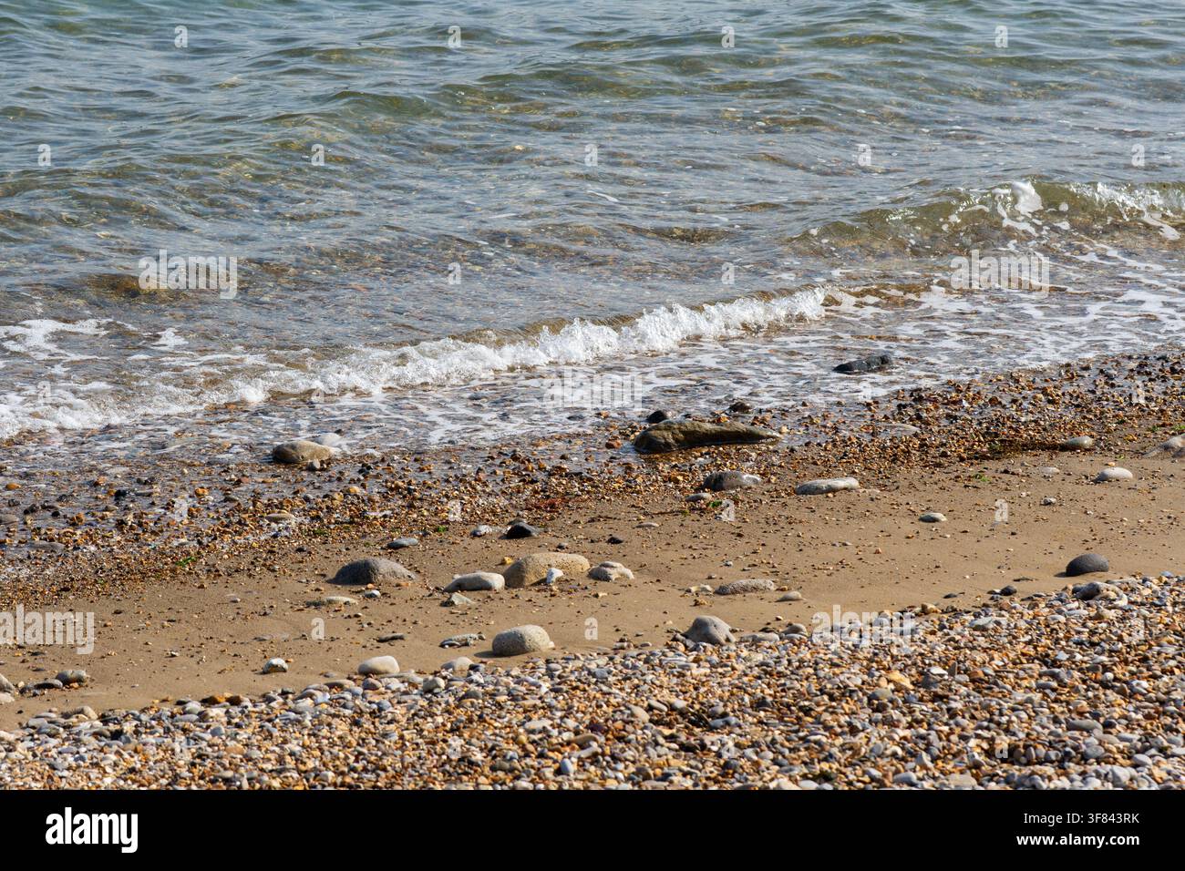 Waves breaking onto the beach Stock Photo