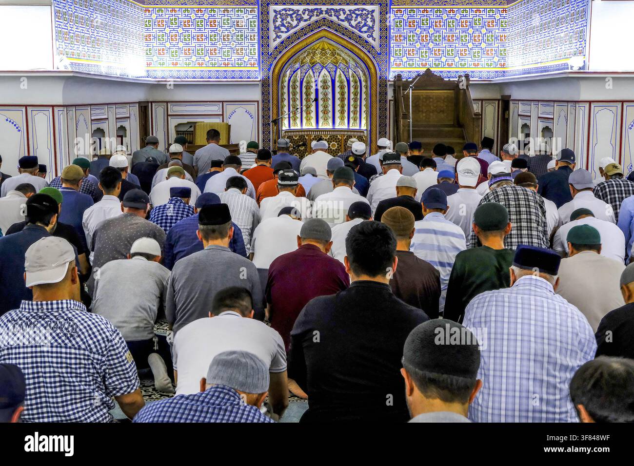 Worshippers gather for prayer inside Bolo Haouz mosque during the afternoon prayer in Bukhara, Uzbekistan Stock Photo