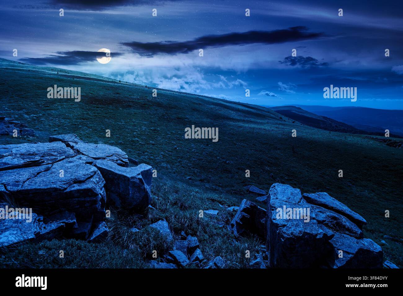 carpathian mountain landscape on summer night. mysterious background for outdoor adventure in the dark. transcarpathia green hill with rocks in foll m Stock Photo