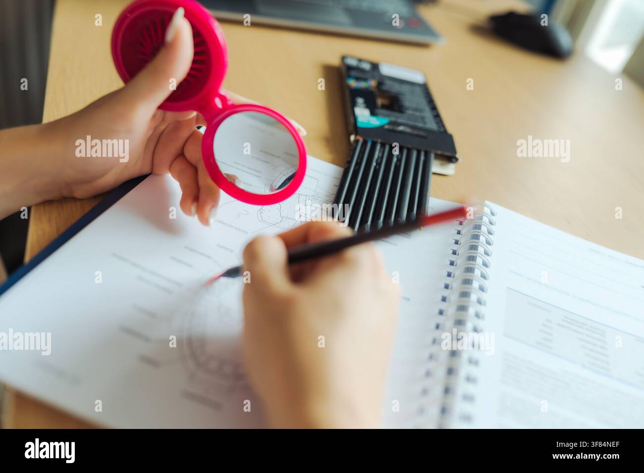 Person practicing mirror writing technique on paper Stock Photo