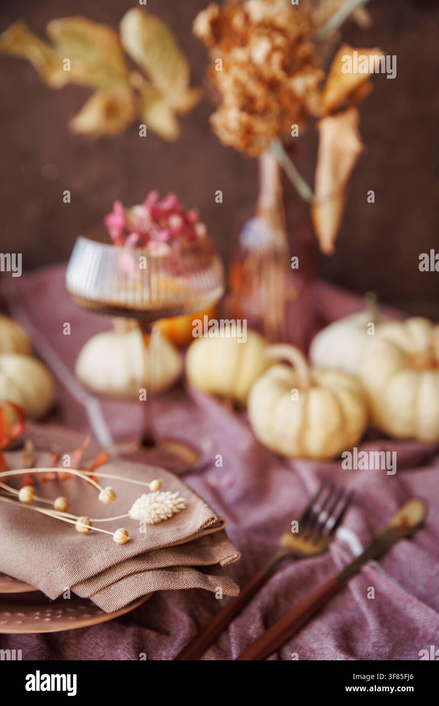 Autumn-themed dining table with pumpkins and stylish decor Stock Photo