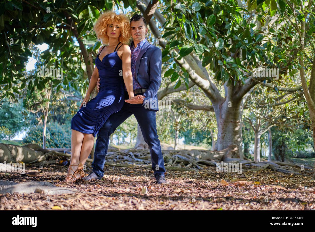 Couple dancing tango with passion and elegance outdoors in a lush park setting Stock Photo