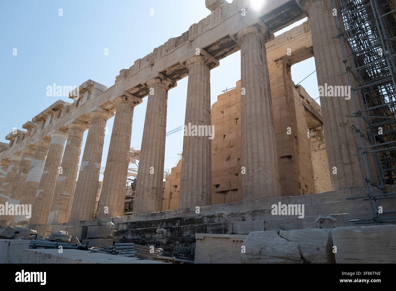 Sunlit fluted Doric columns of the Parthenon seen at a low angle along the colonnade, Acropolis, Athens, Greece. Stock Photo