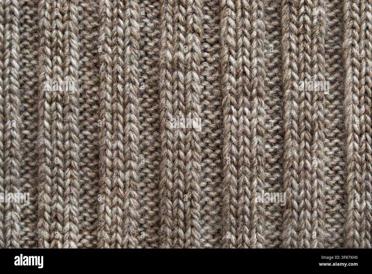 Grey wool yarn knitted texture closeup as a background Stock Photo