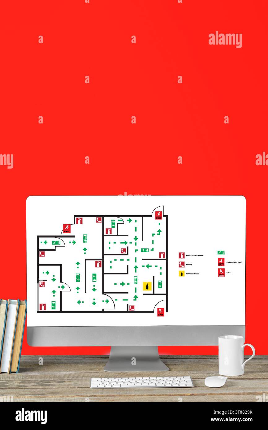 Emergency evacuation plan displayed on computer screen with a red background Stock Photo