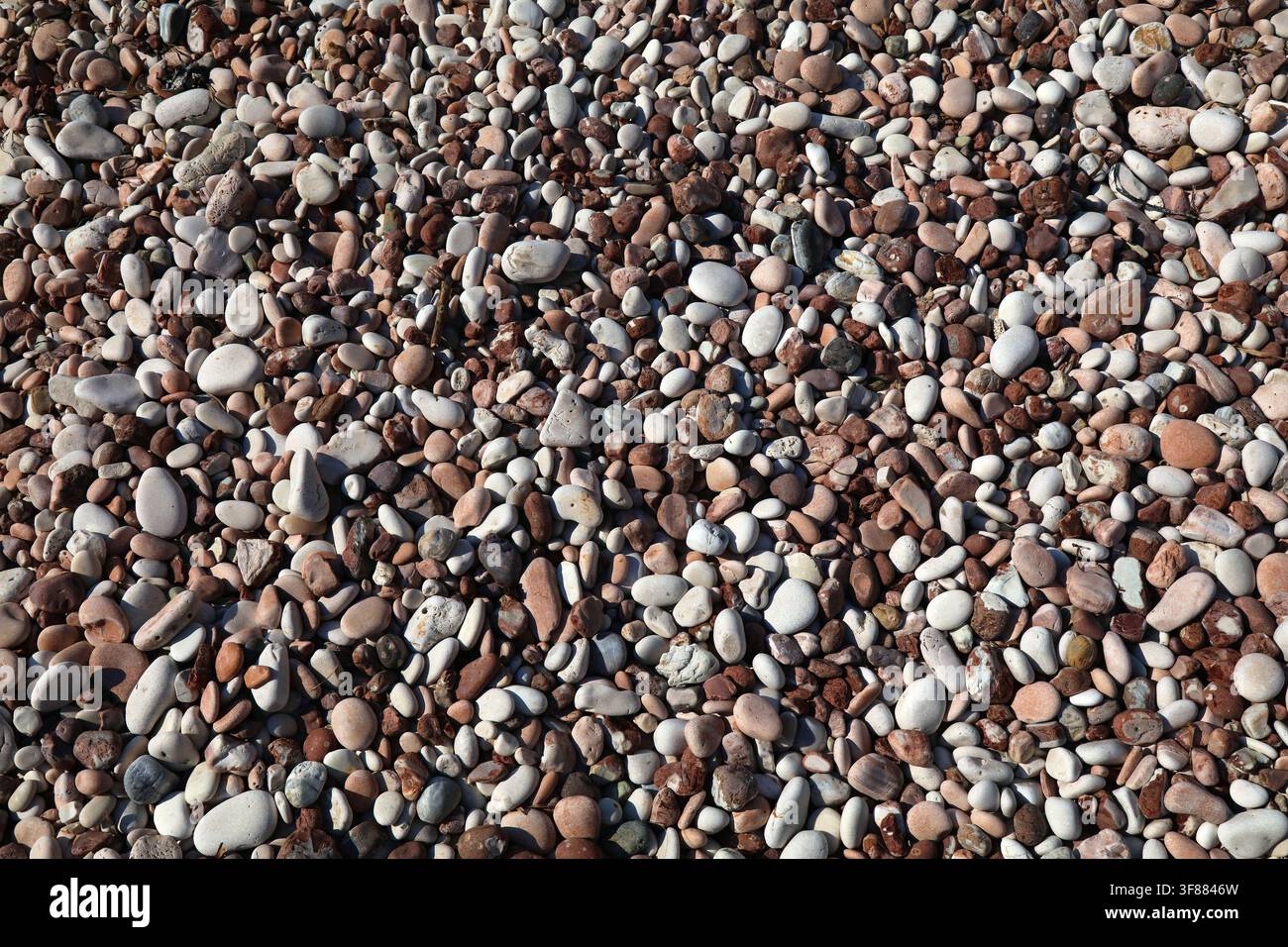 Colorful pebbly beach background from Sarande, Albania. Shingle beach. Stock Photo