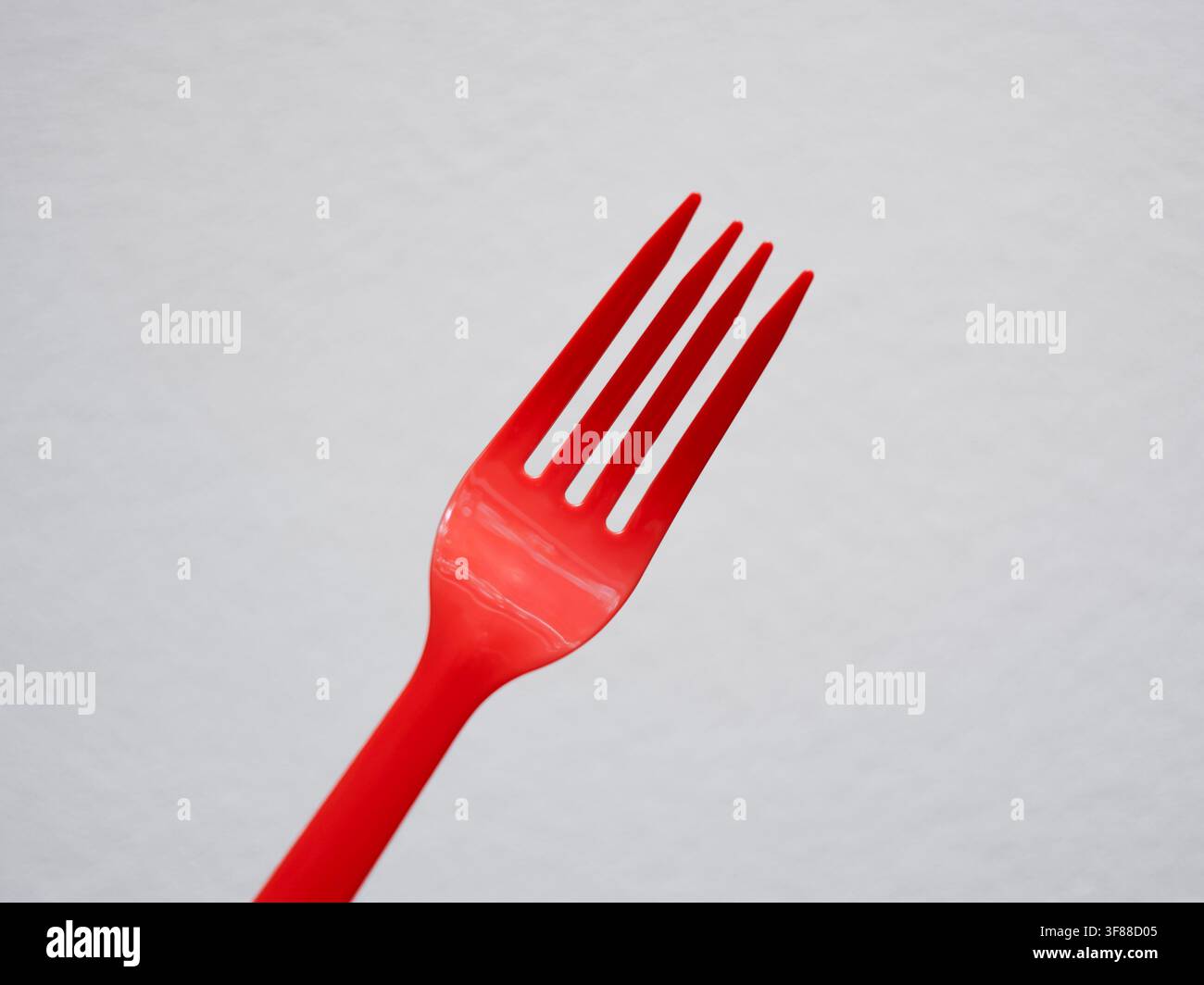 DIsposable red plastic fork from takeout orders Stock Photo