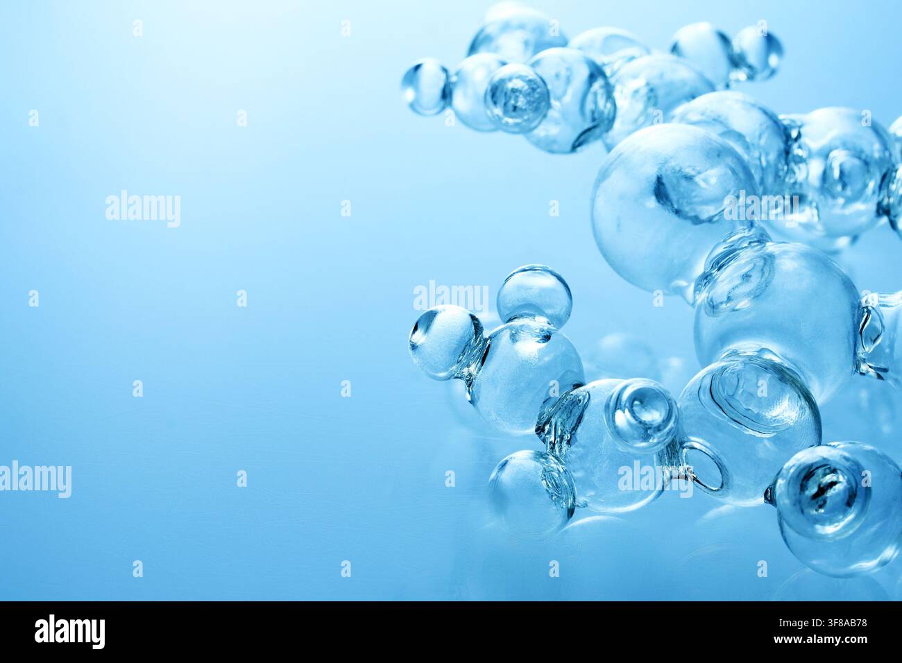 Glass molecules forming abstract scientific structure on blue Stock Photo