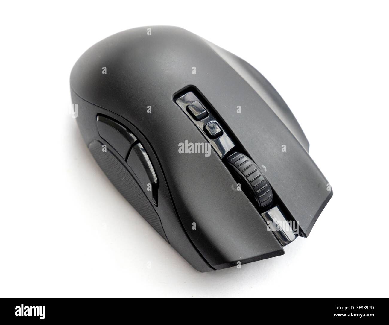 A modern black computer mouse rests on a white background Stock Photo