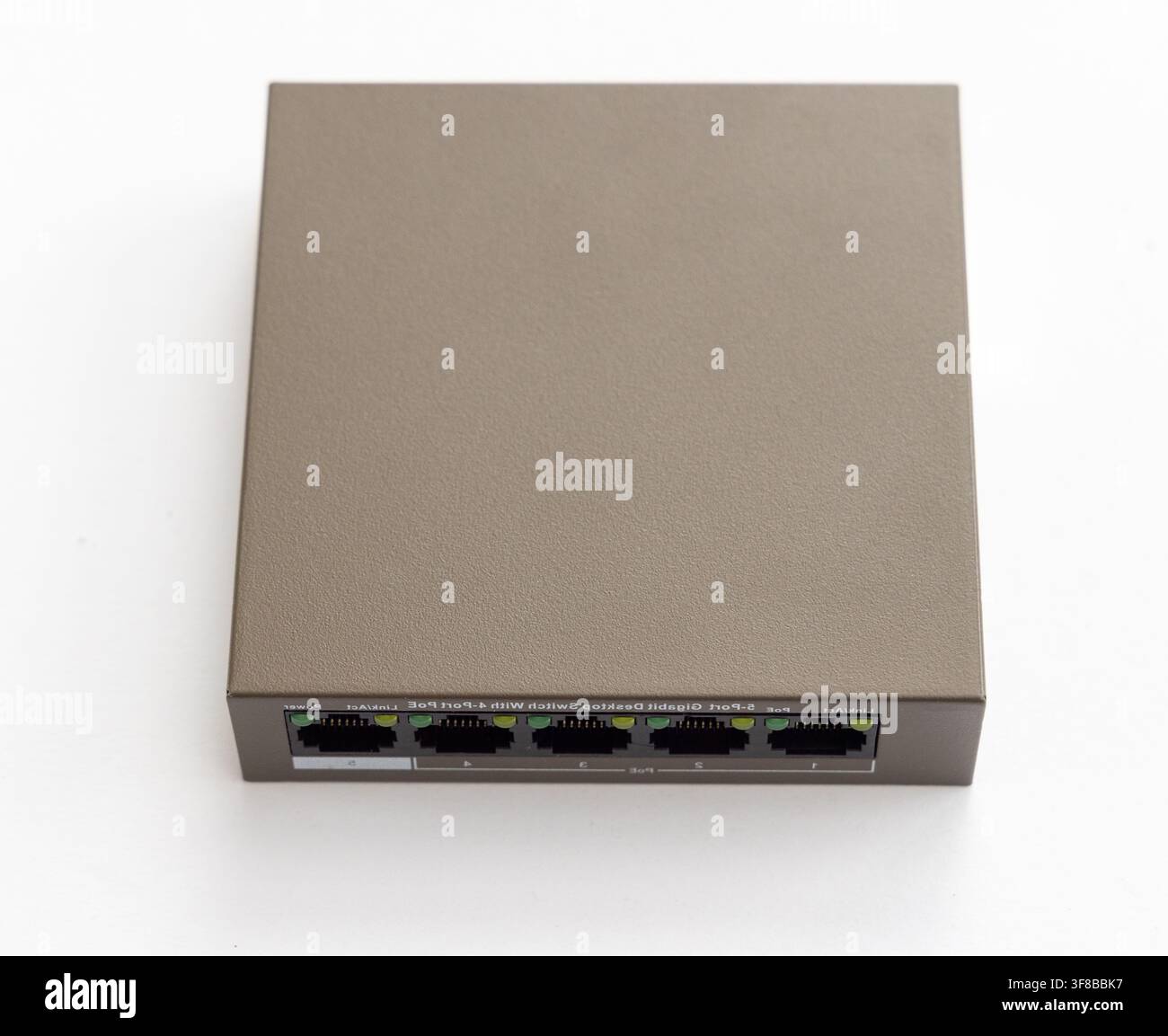 A grey network switch sits on a white background Stock Photo