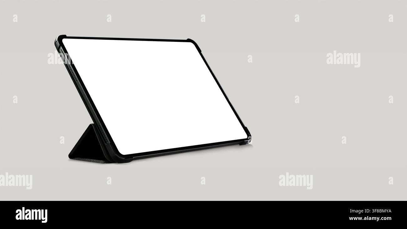 Empty tablet computer screen mockup with black case standing on light grey background Stock Photo