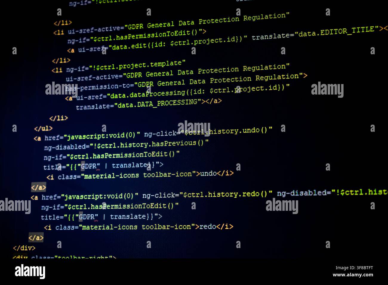 Close-up of GDPR-related HTML source code displayed on a dark computer screen Stock Photo