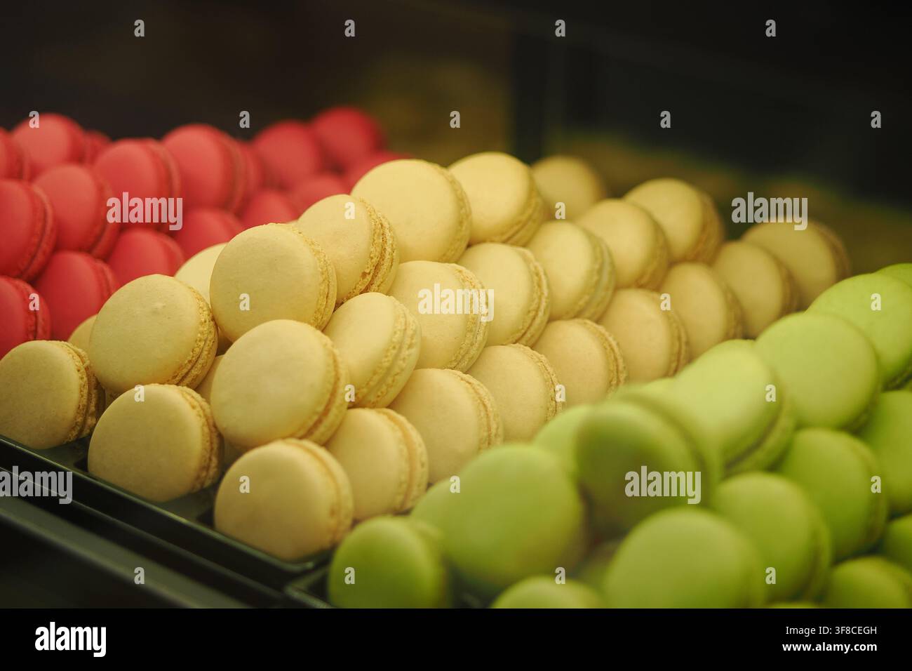 Colorful macarons arranged in a display case Stock Photo
