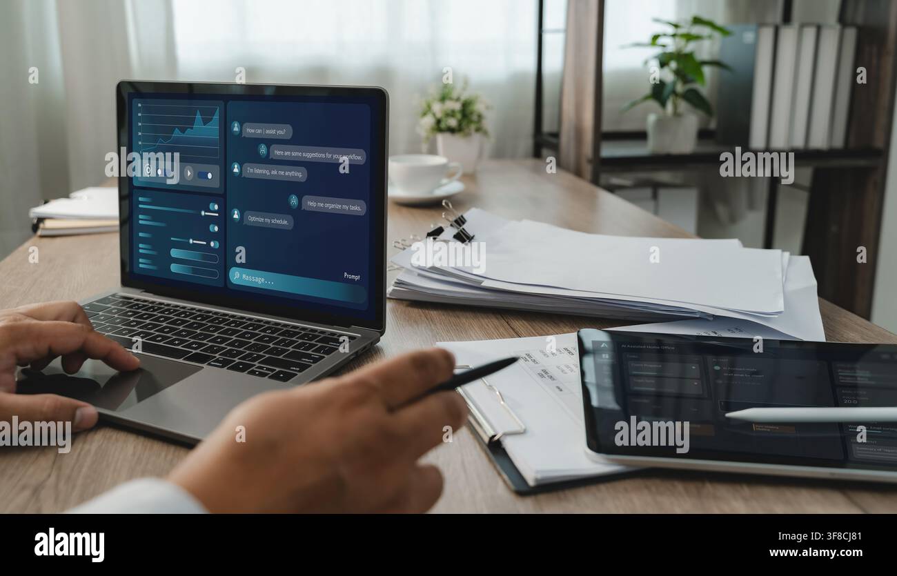 Person uses LLM-based AI chatbot software on a laptop documents, interacting with a digital AI Assisted Home Office interface to organize tasks and su Stock Photo