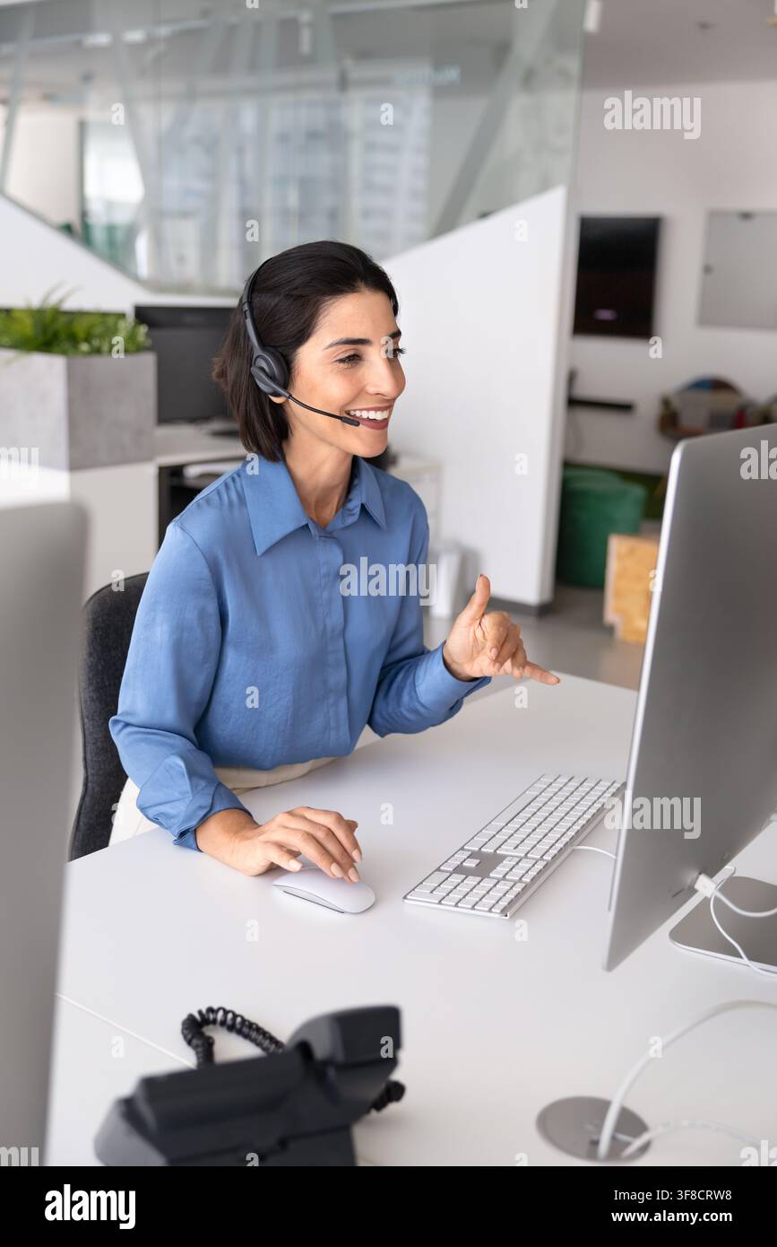 Operator wear headset engaging in remote customer service call Stock Photo