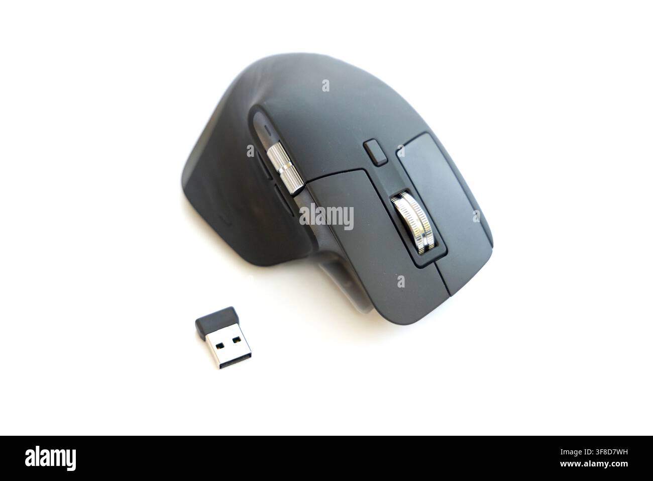 A modern wireless computer mouse sits next to its USB receiver Stock ...