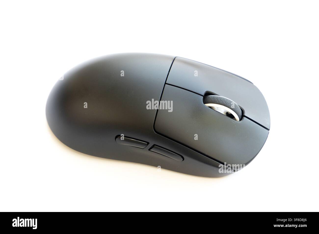 A modern black computer mouse rests on a white background Stock Photo ...