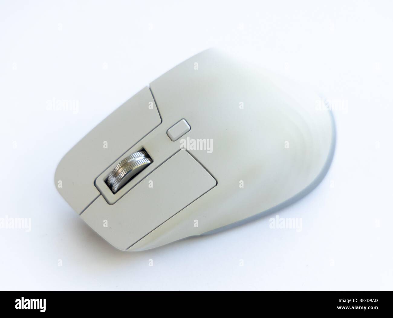 A modern grey computer mouse rests on a white background Stock Photo ...