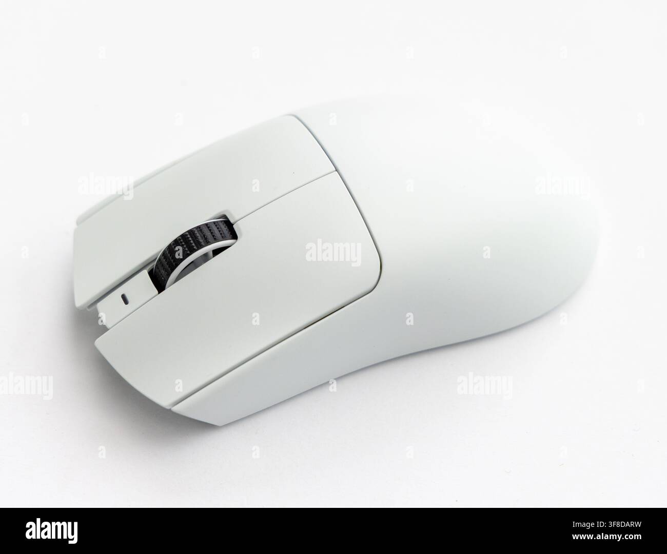 A modern white computer mouse sits on a white background Stock Photo