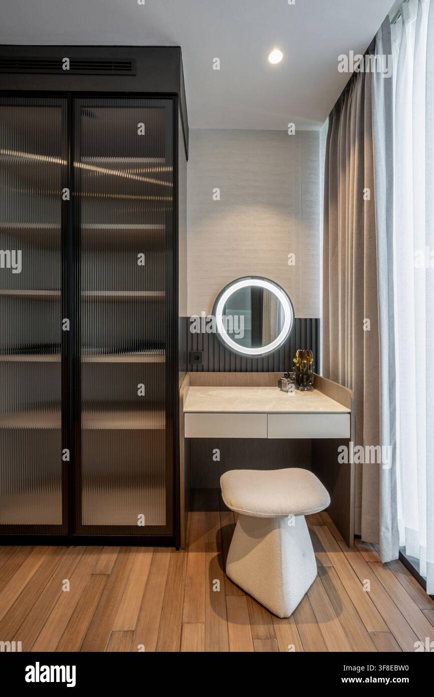 Modern bedroom with dressing table by window Stock Photo