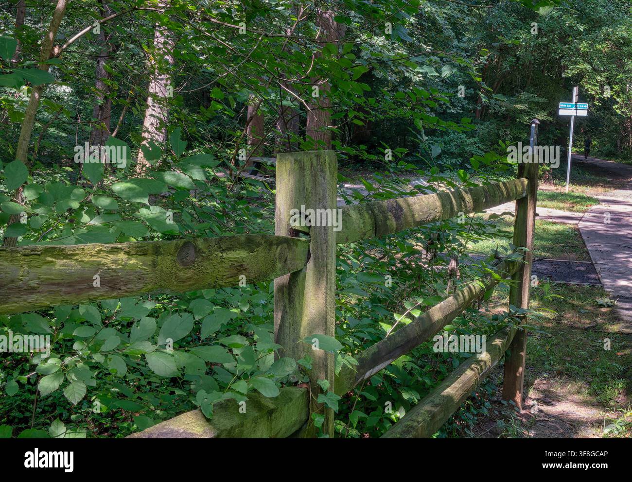 A rustic, weathered wooden split-rail fence Stock Photo