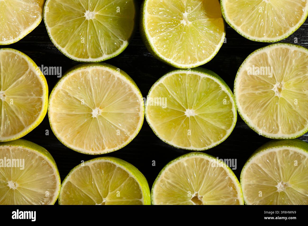 sliced lime on black background top view Stock Photo