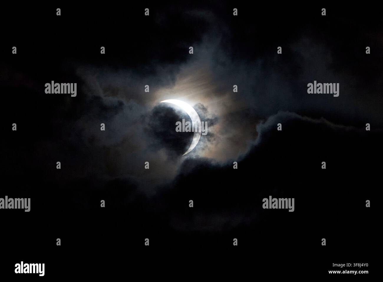 partial solar eclipse as seen through the cloud over belfast lough, 12th august 2026 Stock Photo