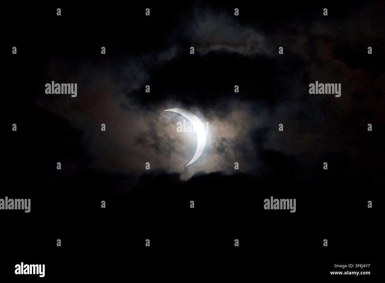 partial solar eclipse as seen through the cloud over belfast lough, 12th august 2026 Stock Photo