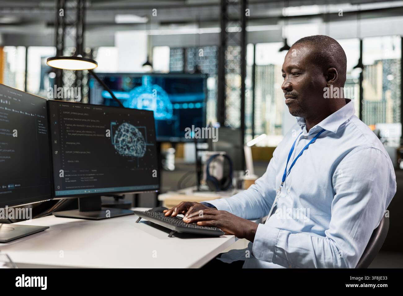 System administrator in office automating repetitive tasks using AI scripts on PC. IT specialist uses artificial intelligence tech on computer to speed up feature implementation Stock Photo