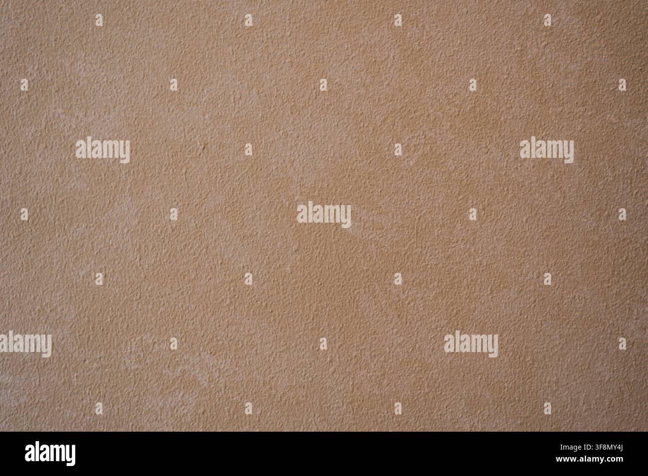 Light brown textured plaster wall surface background. Stock Photo