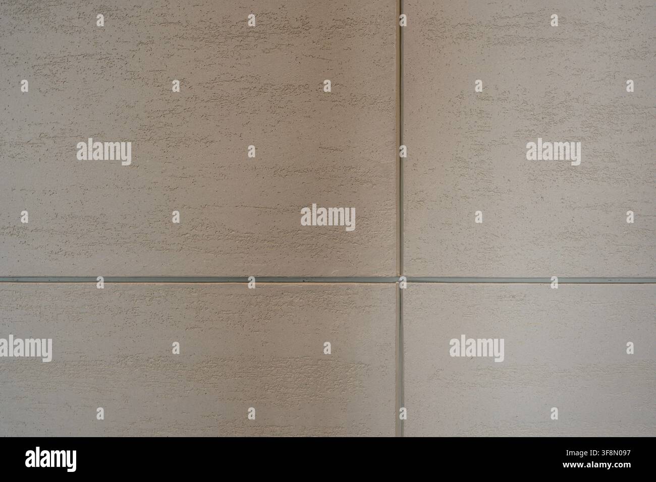 Light beige textured plaster wall surface background with grid lines. Stock Photo