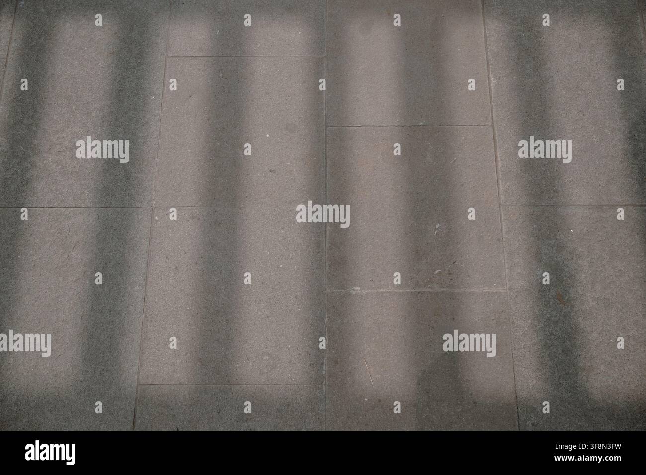 Shadow patterns on concrete pavement or wall tiles. Stock Photo
