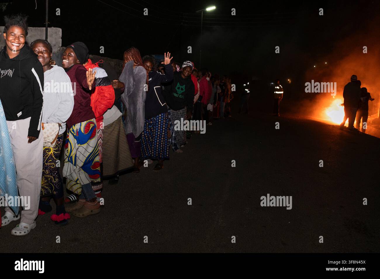 Zambians queue outside a polling station on the outskirts of Lusaka ...