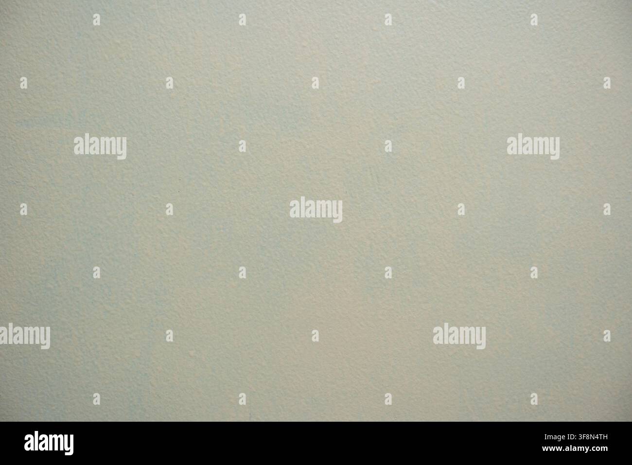 Light gray painted wall texture background with subtle stippled surface details. Stock Photo