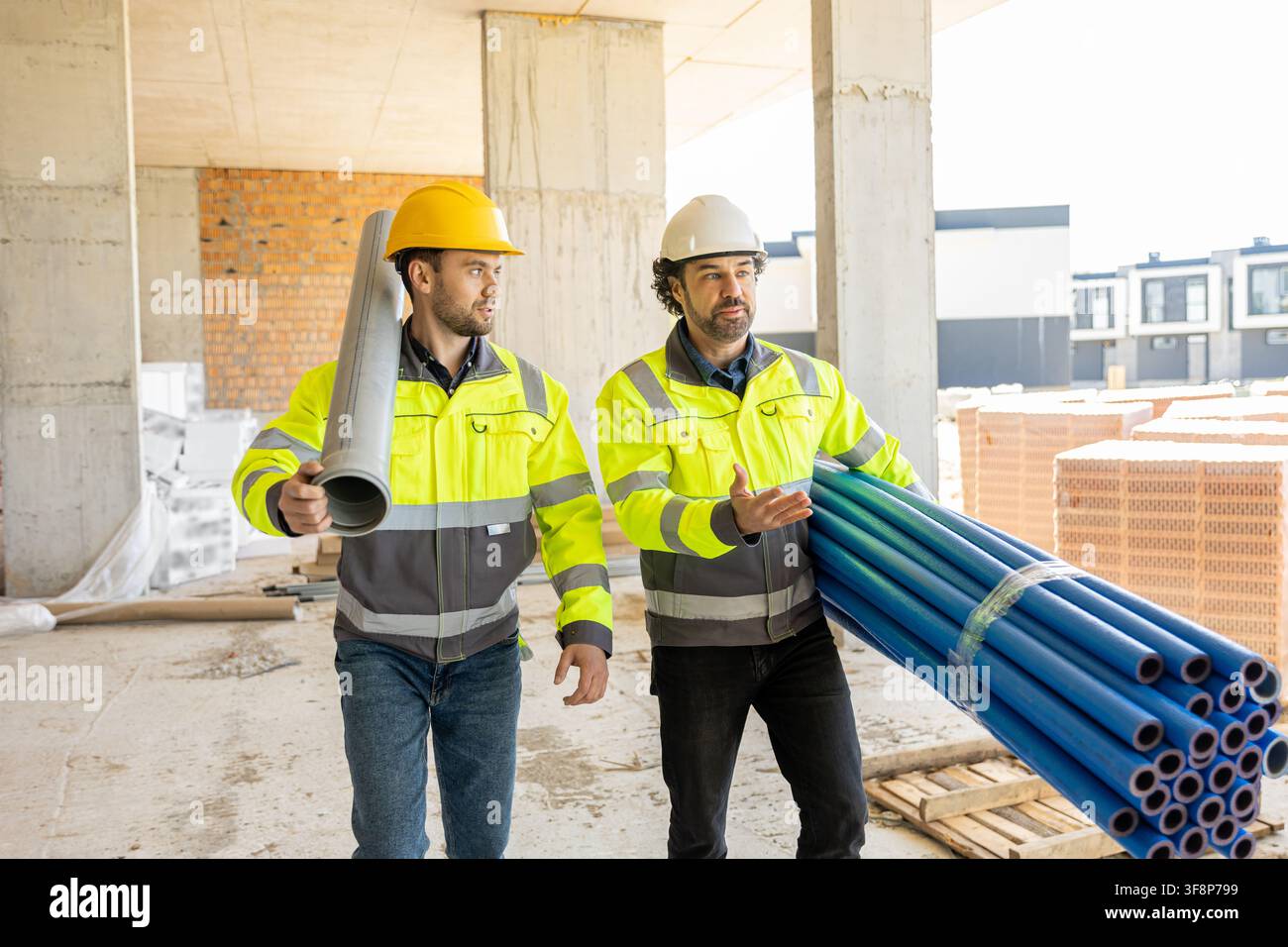 Two professional engineers walking and discussing project Stock Photo