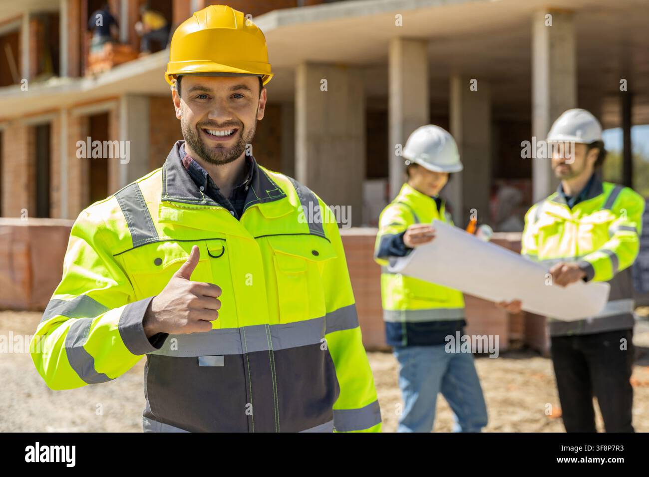 Happy male constructor showing thumb up sign Stock Photo
