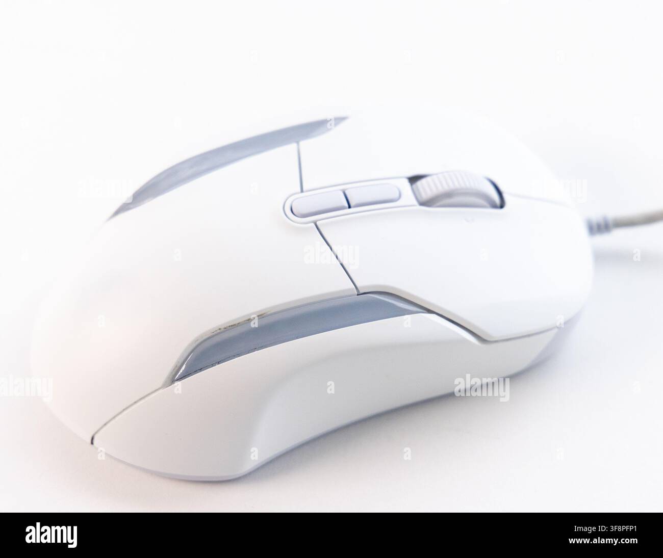 A modern white computer mouse sits on a clean white background Stock Photo