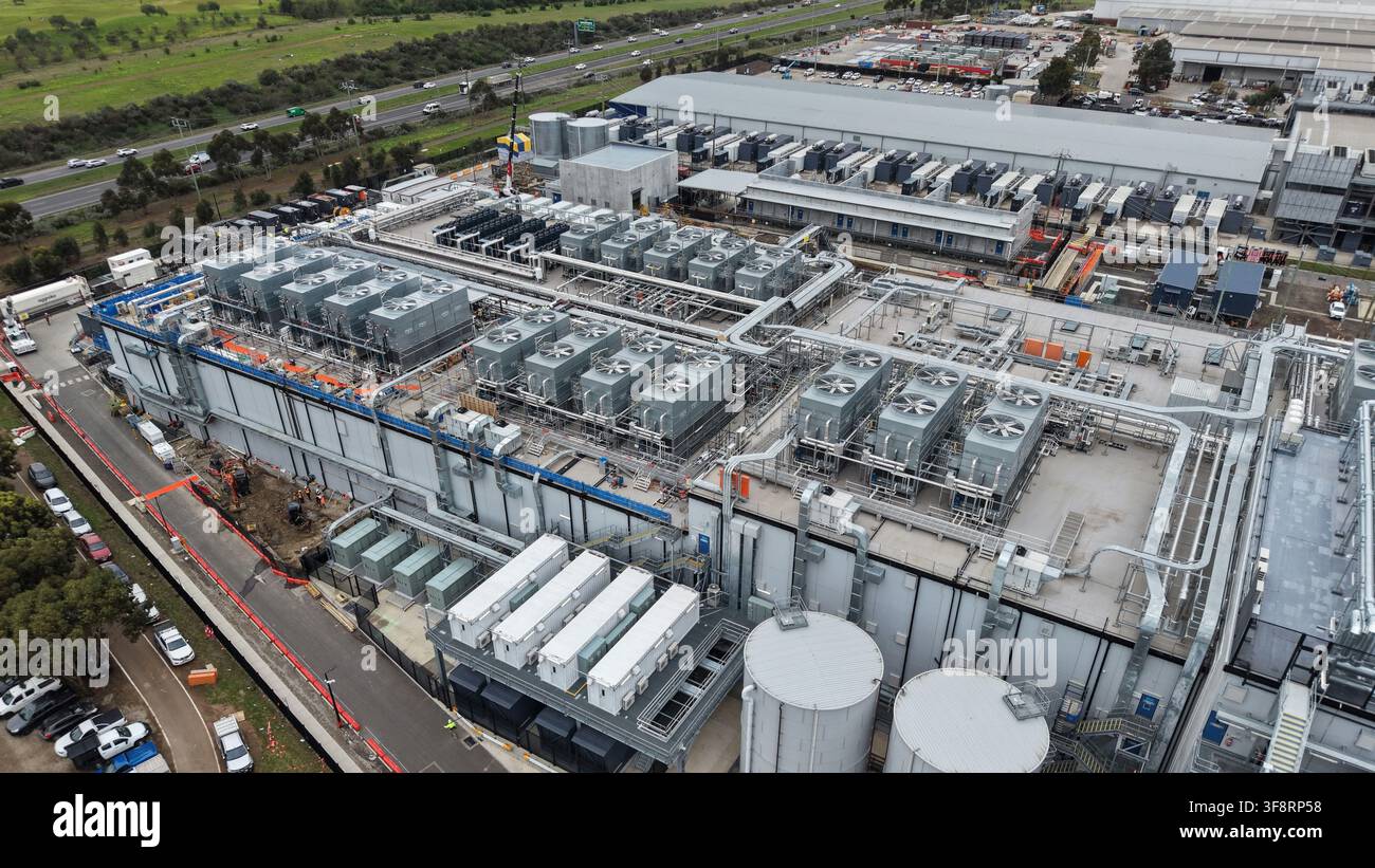 Large data center facility with multiple cooling units located by a highway Stock Photo