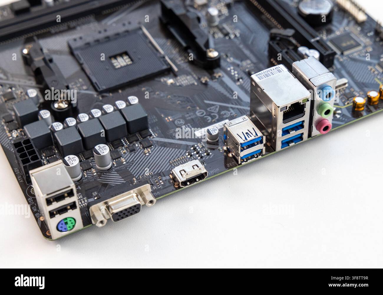 A closeup shot details the intricate components of a computer motherboard Stock Photo