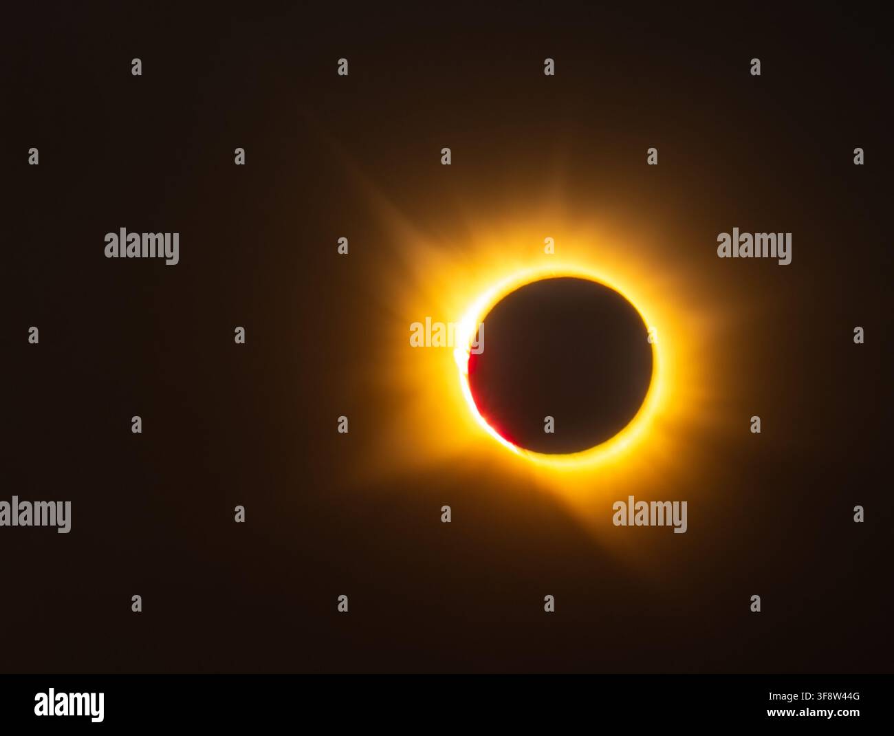 Total solar eclipse with corona and red prominence Stock Photo
