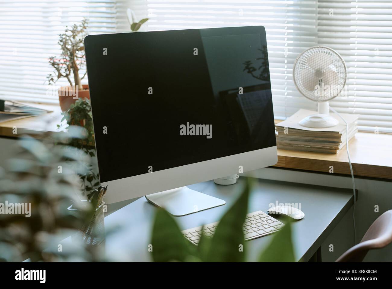 Empty Computer Screen on Desk in Modern Office Workspace Stock Photo