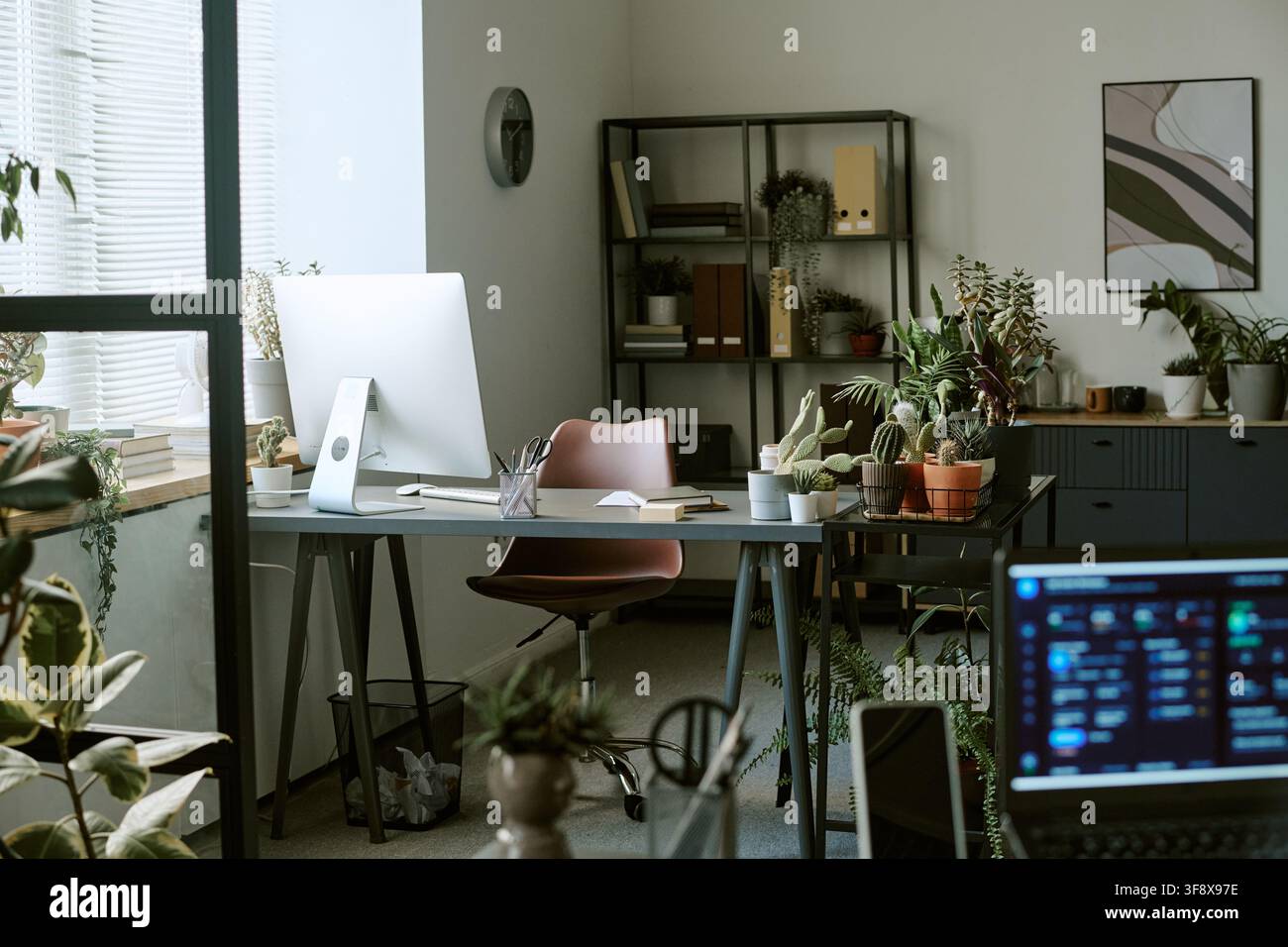 Empty Modern Office Workspace with Computer and Green Plants Stock Photo