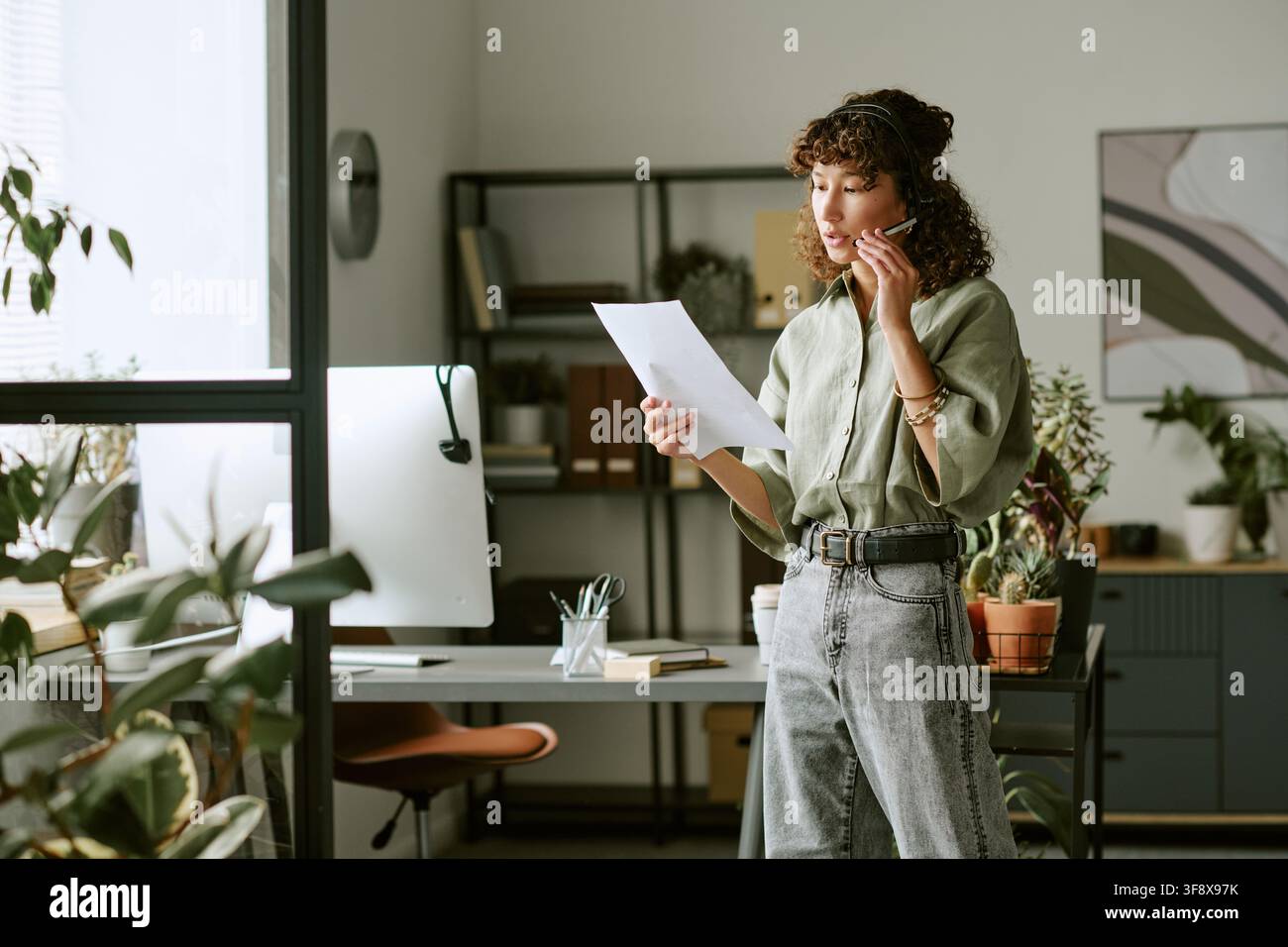 Young Woman Working in Call Center and Consulting Clients Stock Photo