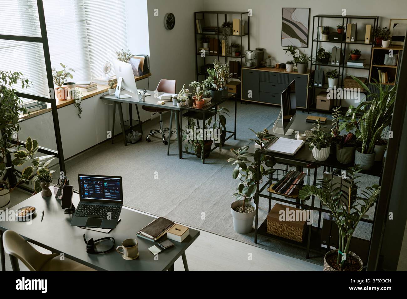 Empty Modern Office with Green Plants and Computers Stock Photo