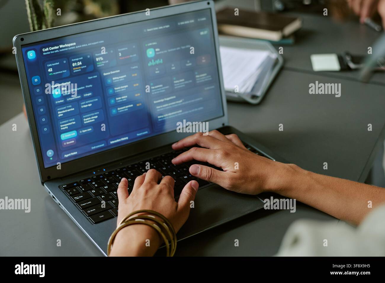 Female Employee Working in Call Center Using Laptop Stock Photo