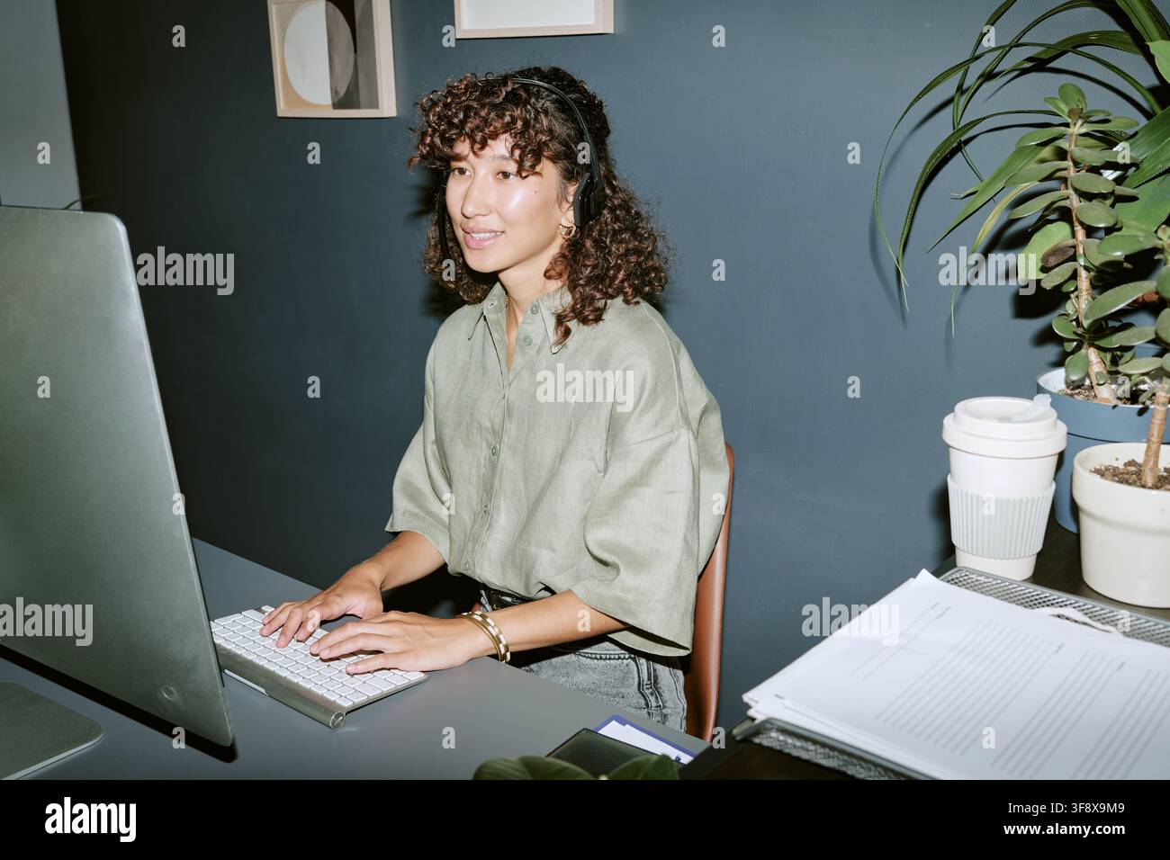 Young Woman Working in Call Center Using Computer Stock Photo