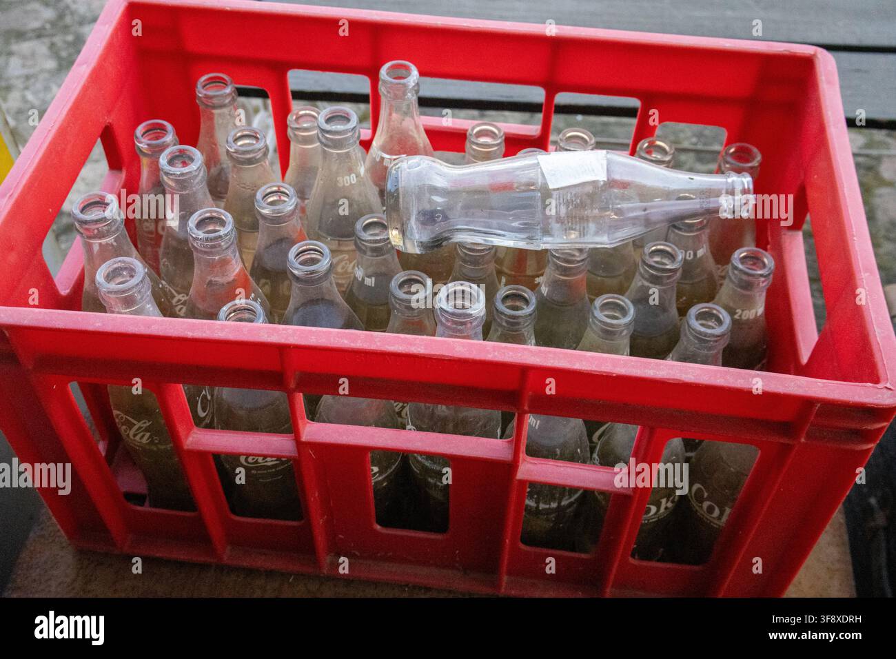 Clear glass bottles in a red crate Stock Photo