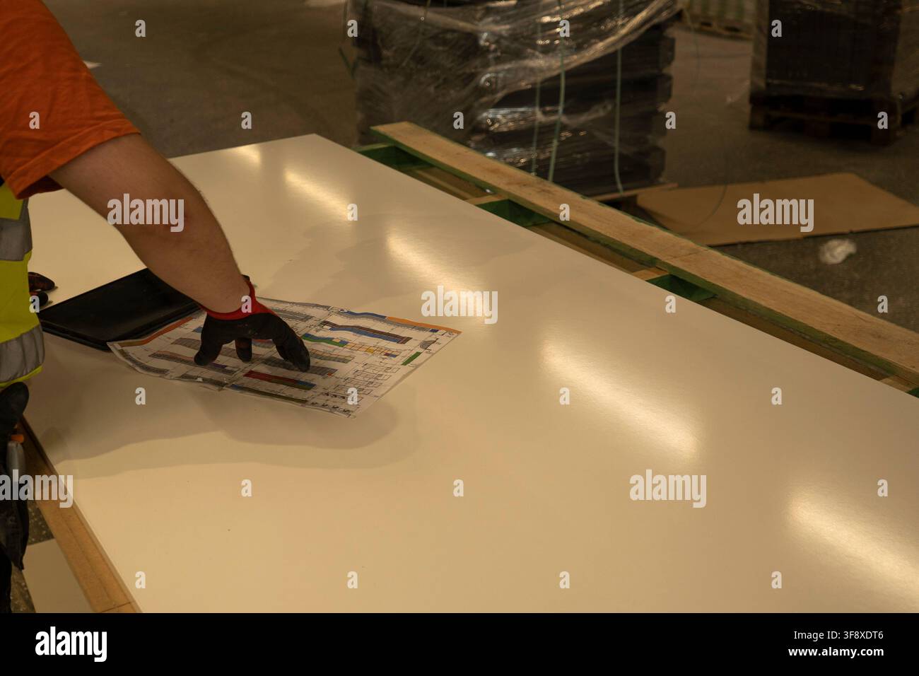Worker pointing at store layout blueprint plan Stock Photo