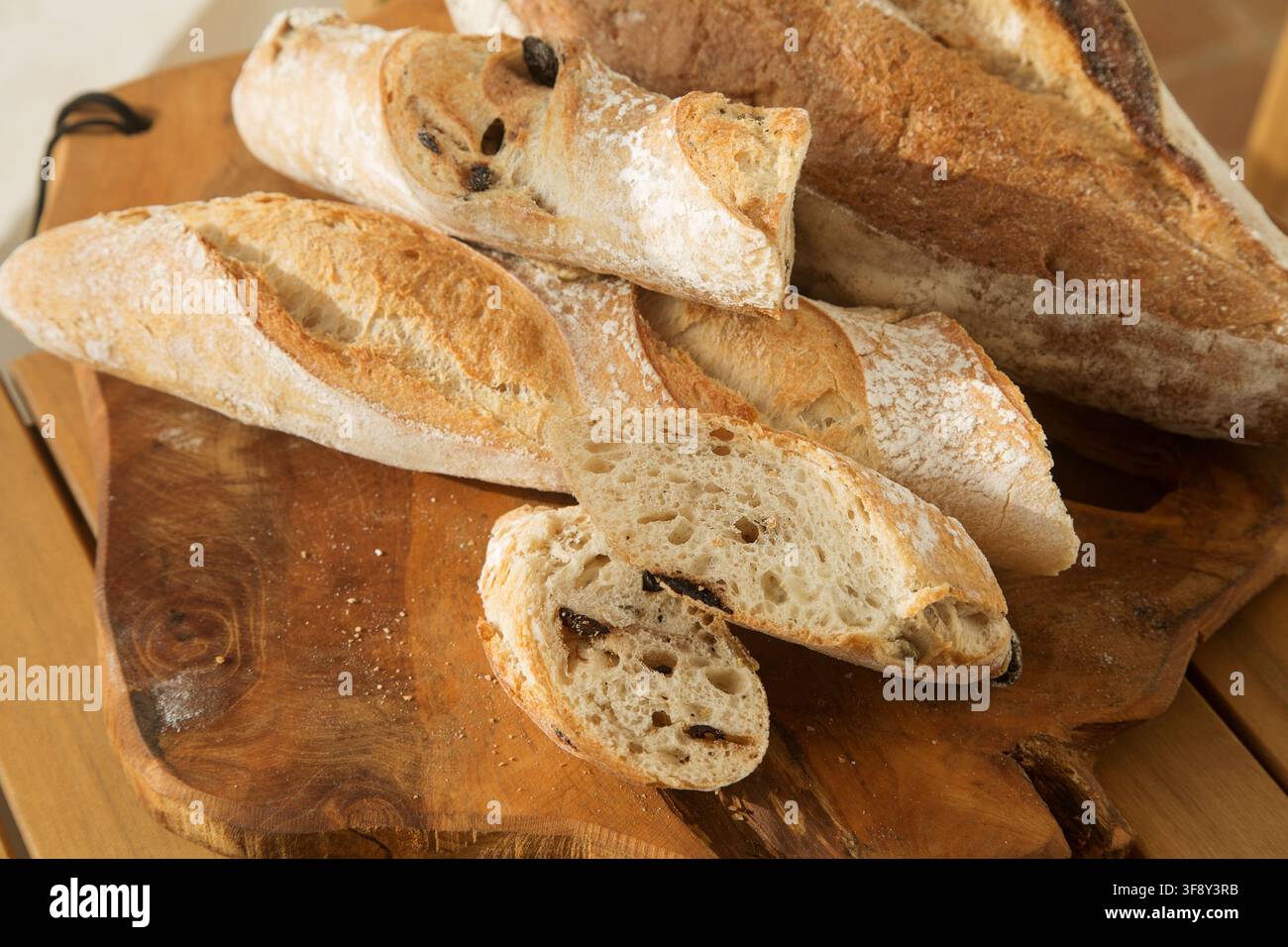 serving bread for Breakfast, sliced baguette with olives Stock Photo