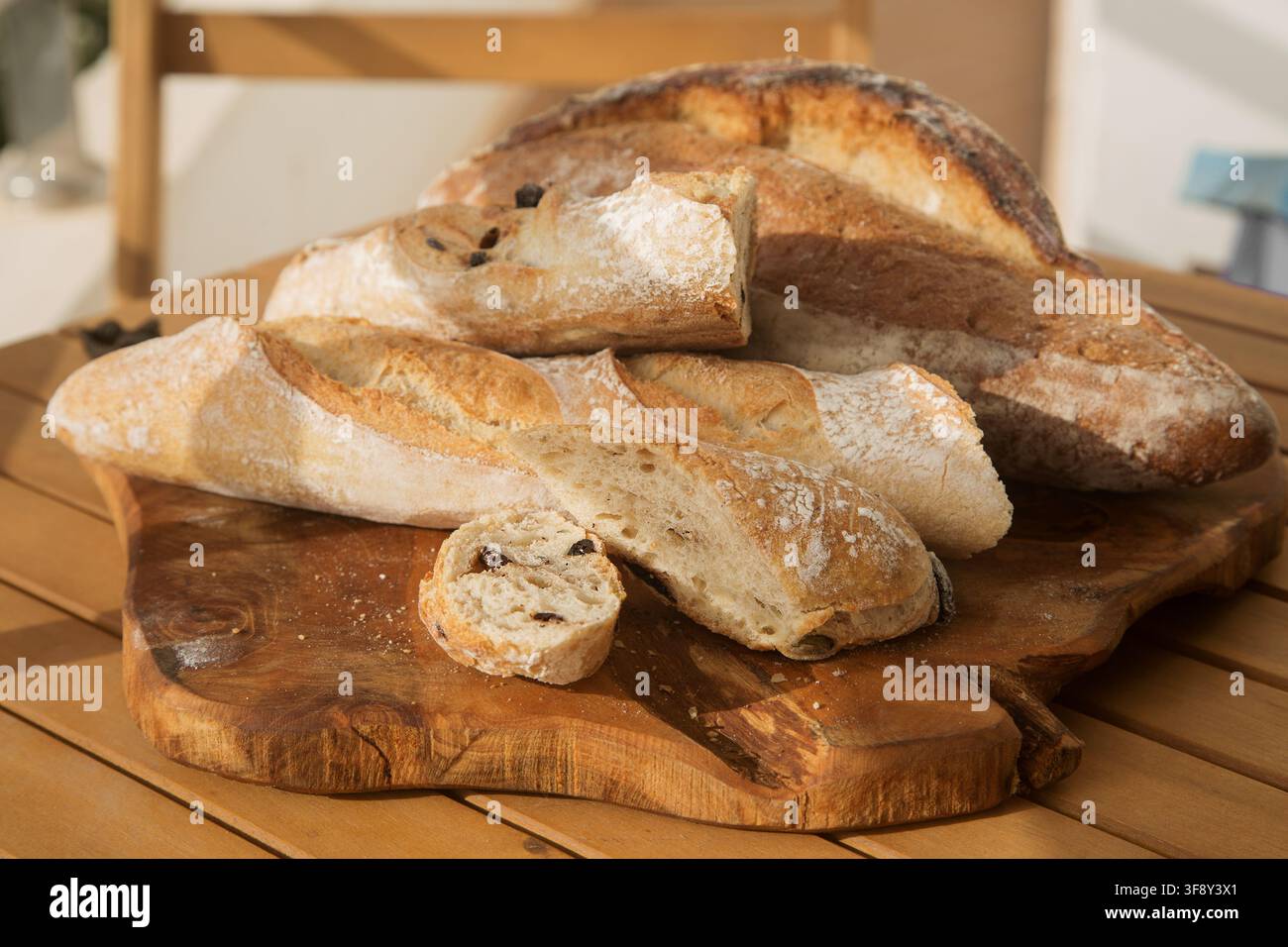 serving bread for Breakfast, sliced baguette with olives Stock Photo